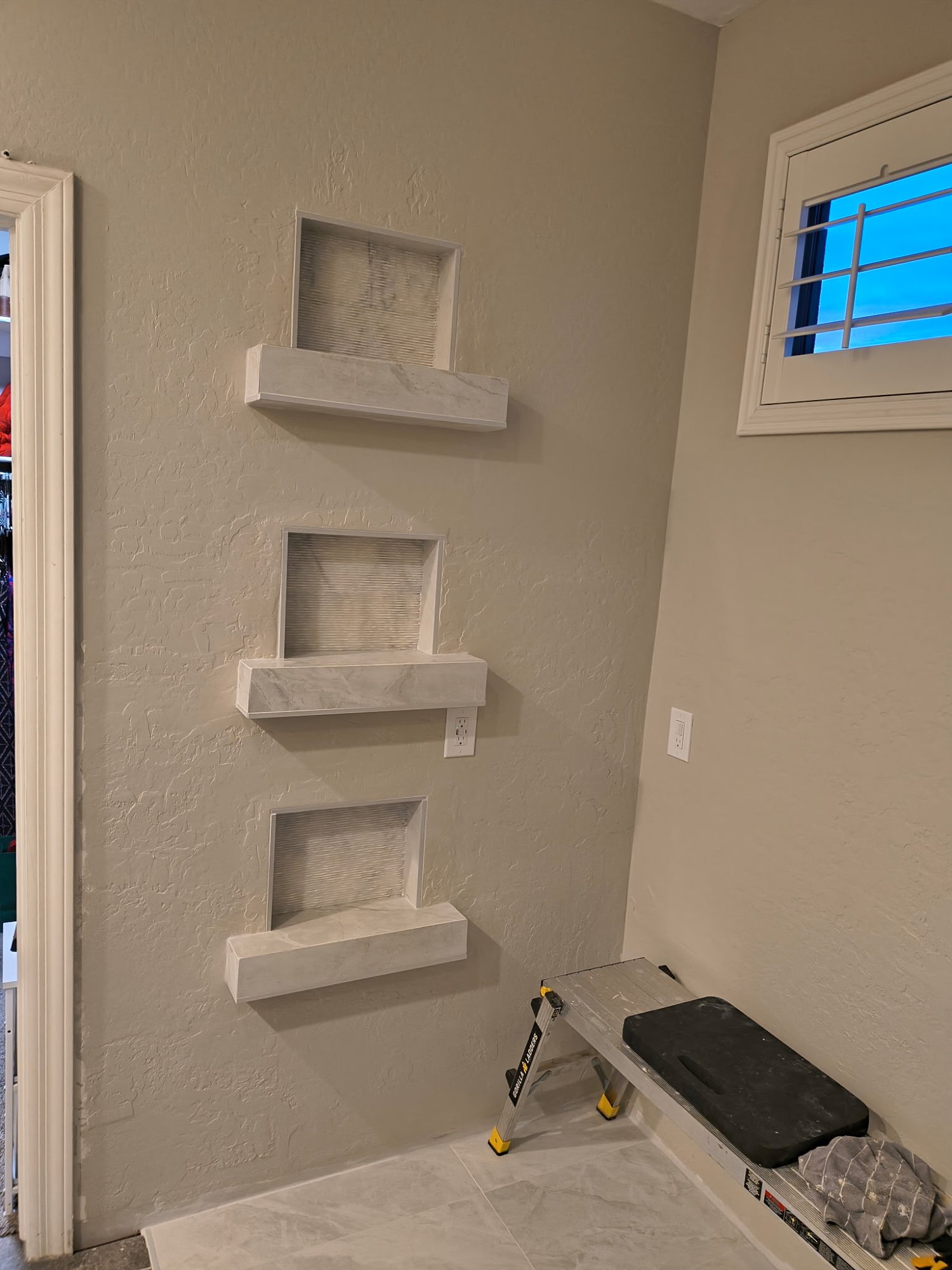 Custom marble niche shelves being built
