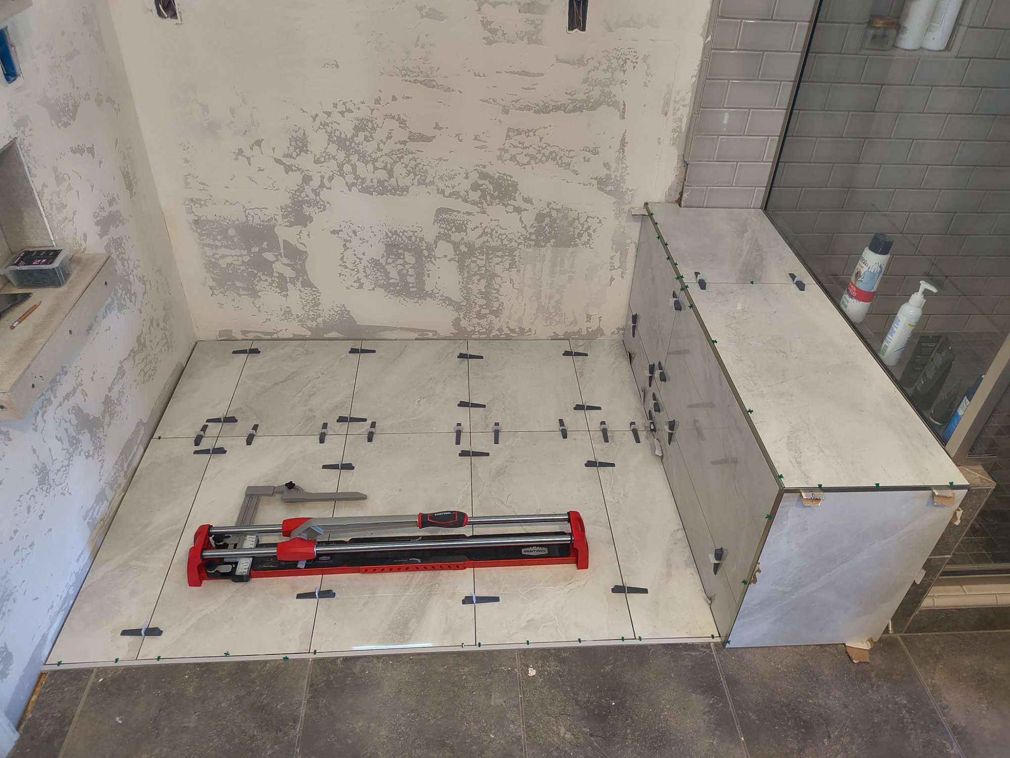 Large format tile layout with spacers and tile cutter